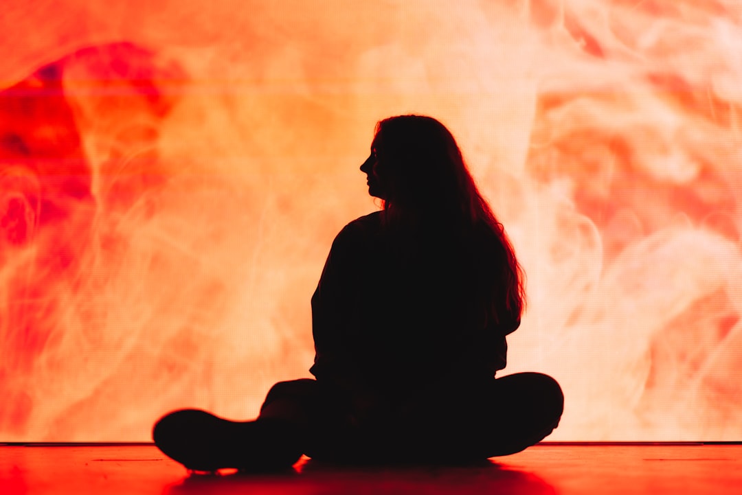 silhouette of woman sitting on floor silhouette of woman sitting on floor