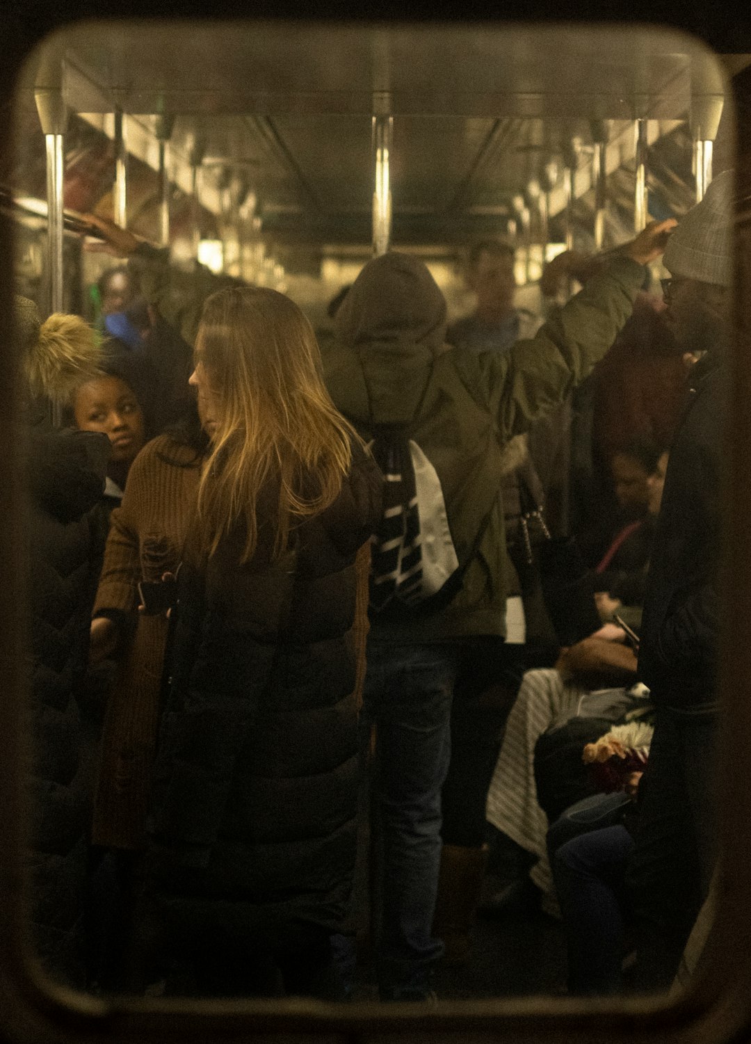 woman in black jacket standing in front of people