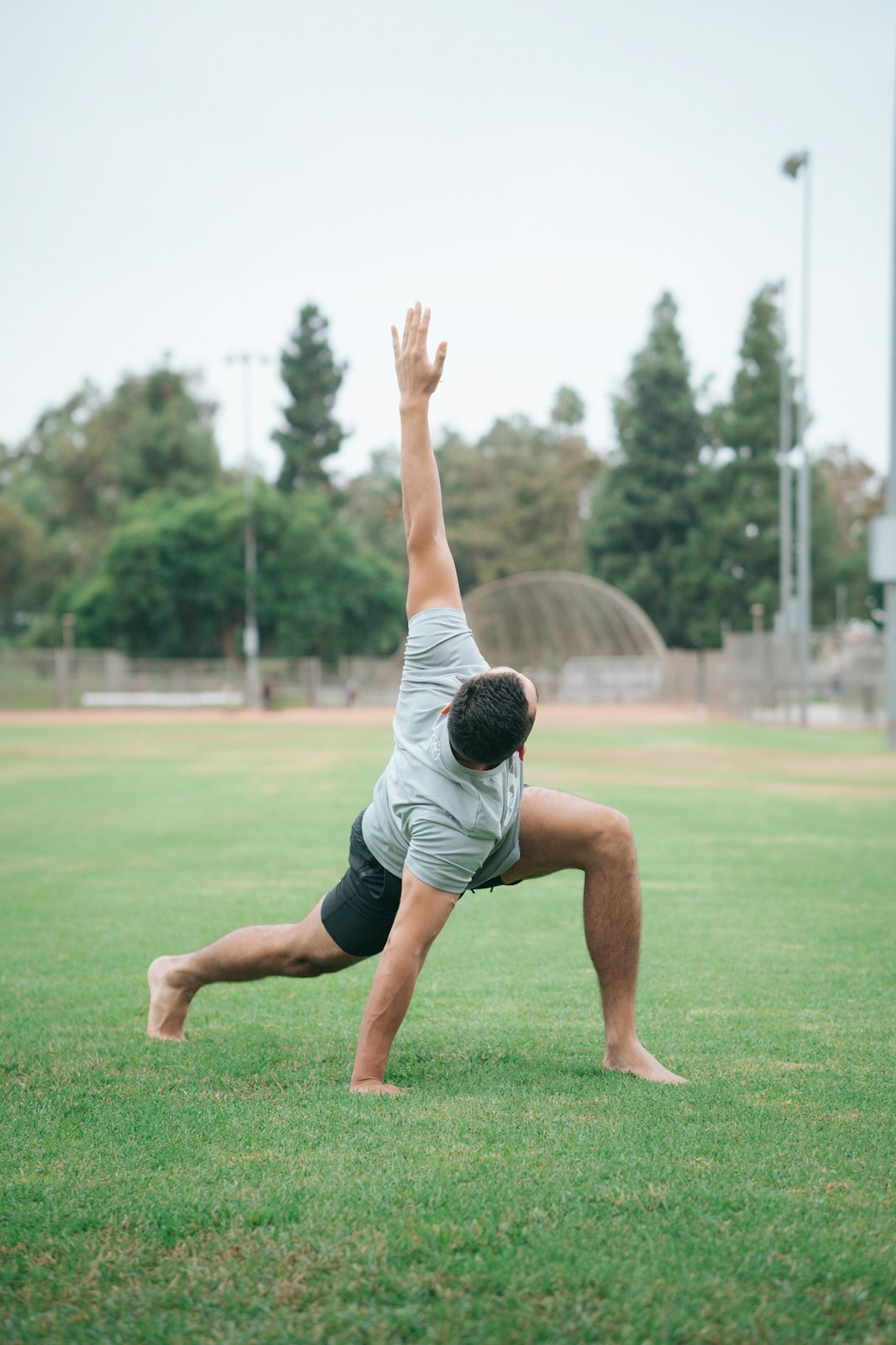 man in black and white t-shirt and black shorts sitting on green grass field during man in black and white t-shirt and black shorts sitting on green grass field during