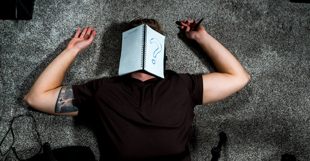 person in black shirt holding white paper person in black shirt holding white paper