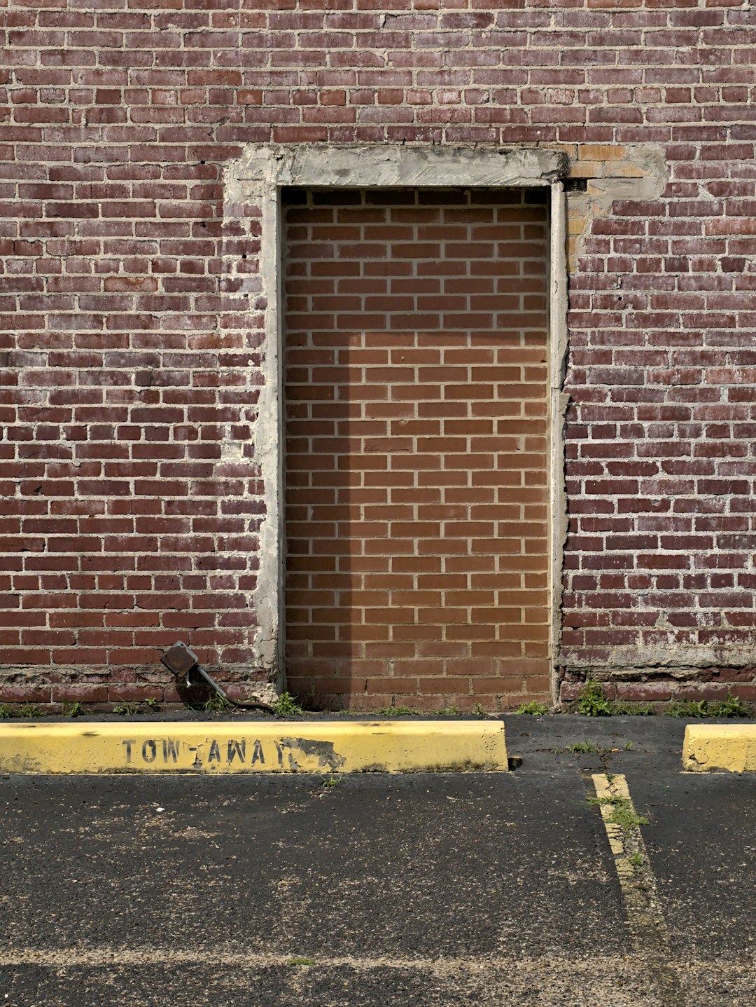 brown brick wall with black and yellow caution sign brown brick wall with black and yellow caution sign