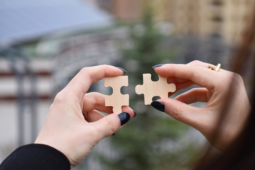 a few hands holding a small white object a few hands holding a small white object